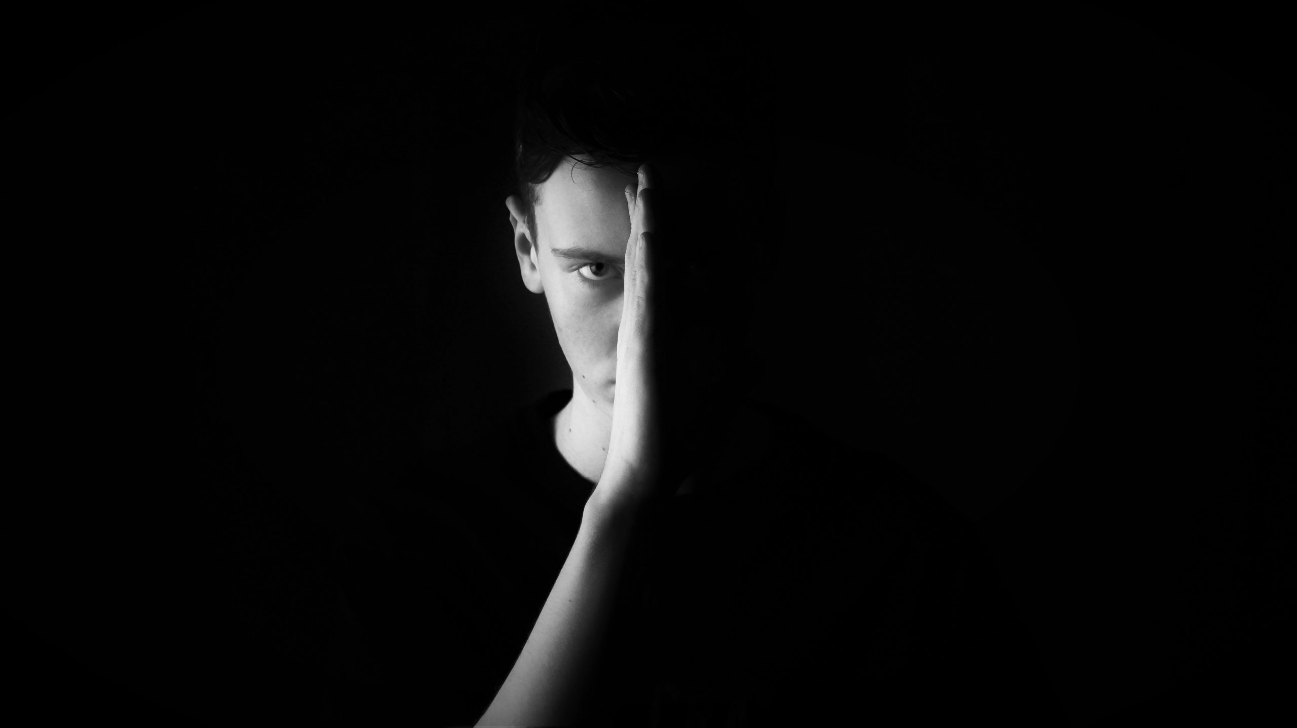 image of woman covering half of her face